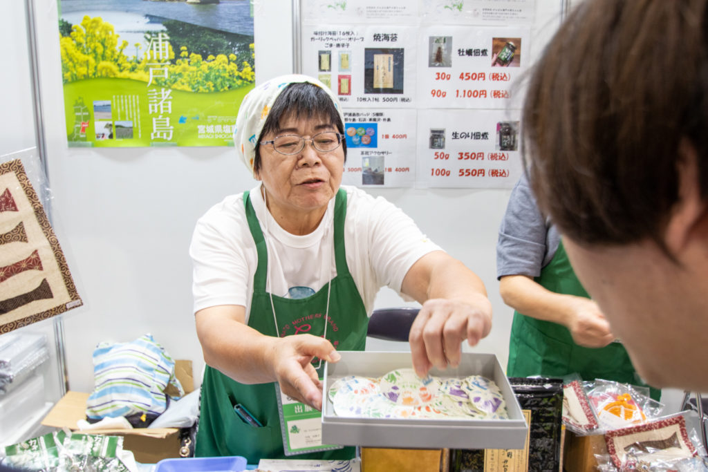ステッカーを差し出す母ちゃん会の方